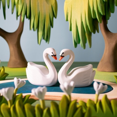 Swans on a heart lake, a Bumbu Toys creation, where love meets nature.