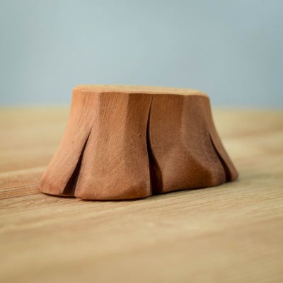 Tree Stump and Lovebirds set displayed in a hand, highlighting its compact size and intricate design.