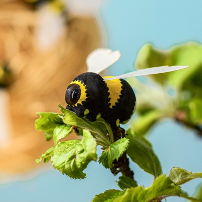Wooden bumblebee inside a blue flower