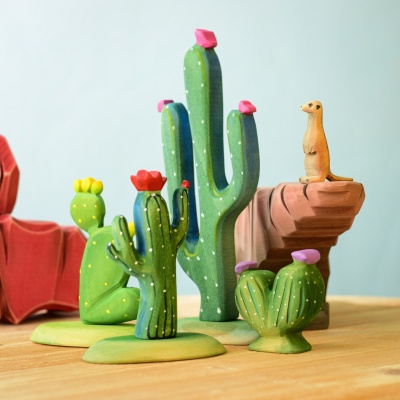 Wooden pin cushion cactus in a desert scene with other wooden figures