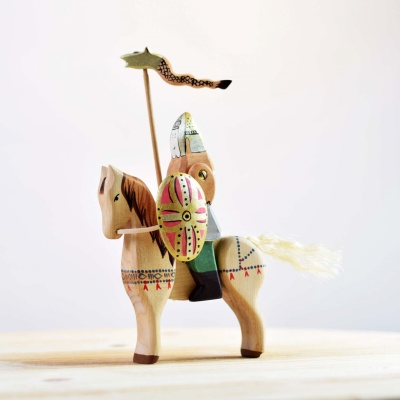 Image of the Steed wooden horse being used in a pretend play scene with other toys.