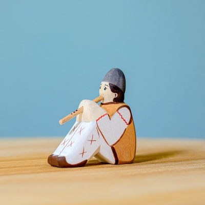 Close-up of the Shepherd's face, hand-painted features, and wooden flute.