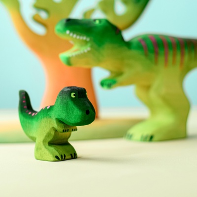 Handcrafted Dinosaur T-Rex Baby wooden toy by Bumbu Toys on natural background