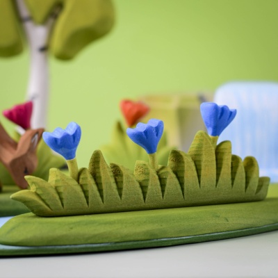 Grass with Blue Flowers Large in a whimsical small-world play scene.