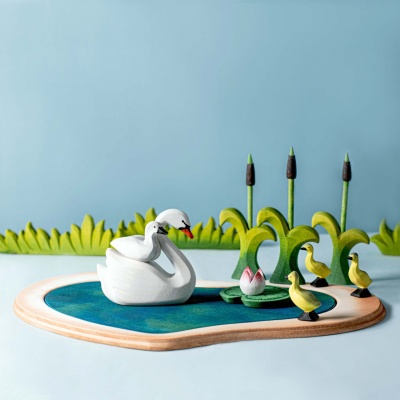 Several Large Grass wooden toys grouped together as a miniature field.