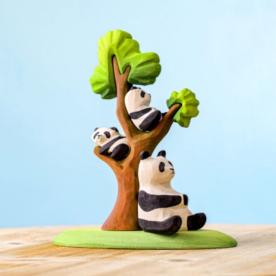 Wooden panda bear cubs playing on and around a tree