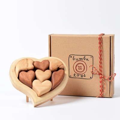 The puzzle packaged in its box, ready for gifting, with a visible ribbon or bow.