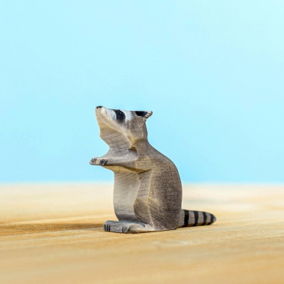 Handcrafted wooden raccoon figurine in a sitting pose