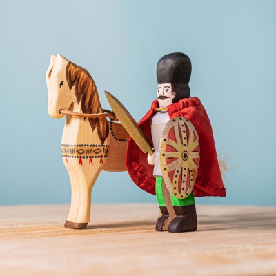 Handcrafted wooden figures of Michael the Brave in armor, riding his powerful steed.