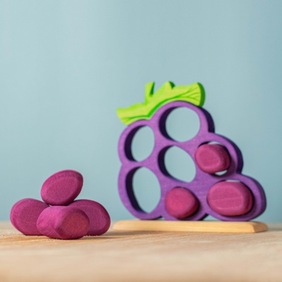 Wooden grapes with removable pieces, fostering fine motor skill development.