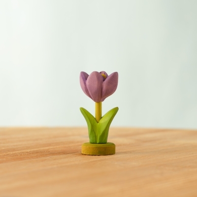 Magical wooden spring scene with a fairy houses and flowers in green stands