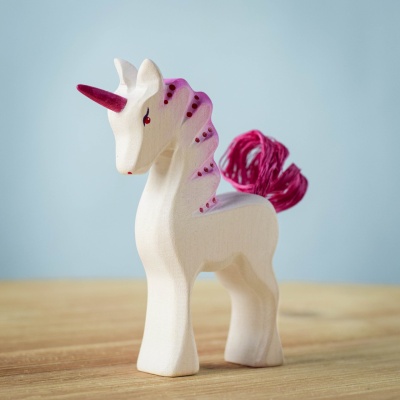 Handcrafted Baby Unicorn Pastel standing on a wooden surface.