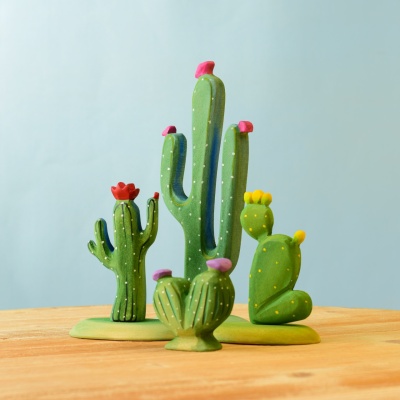 Handcrafted wooden cacti set on a wooden surface