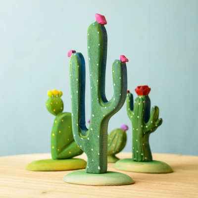 Wooden Mexican cactus with other wooden cacti on a wooden surface