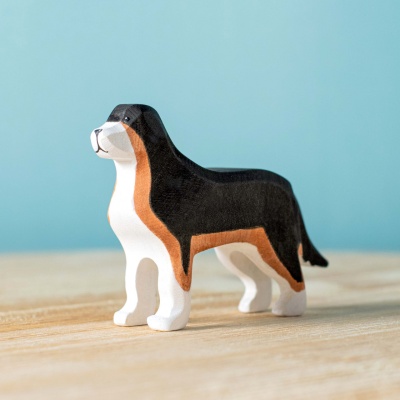 Wooden Berna Sheepdog toy standing proudly on a wooden surface in a well-lit space.