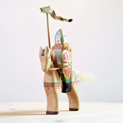 Image of the Steed wooden horse being used in a Waldorf-inspired play scene.