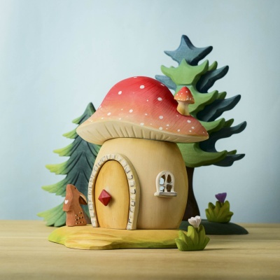 Front view of the Toadstool House, featuring a charming door and window.