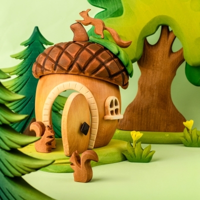 Child removing the small wooden door from the magical acorn house