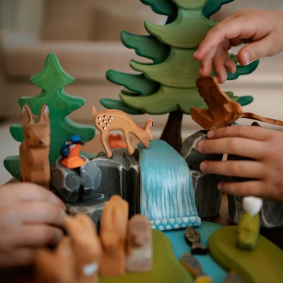 Lifelike wooden deer family, designed for eco-conscious play.