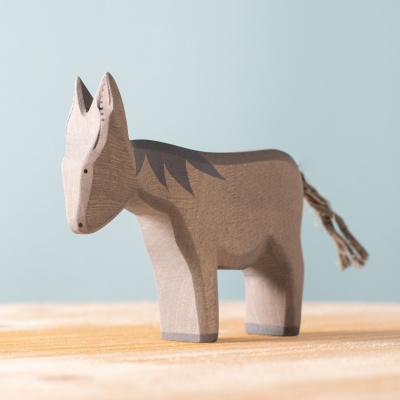 Image of the BumbuToys Donkey Standing alone on a natural wood surface.