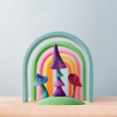 Whimsical wooden mushrooms from BumbuToys, each one dusted with a shimmer of enchantment