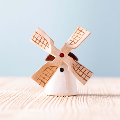 The windmill incorporated into a nature-themed play scene with wooden trees and animals.