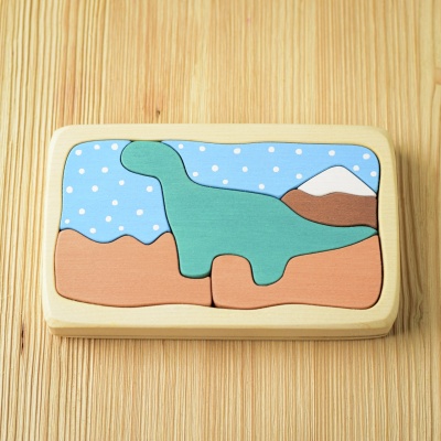 Completed Dinosaur Puzzle displayed on a natural wood surface, showcasing its vibrant designs.