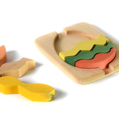 Artisanal Egg Puzzle by BumbuToys, a rainbow of colors in a charming wooden stacker.