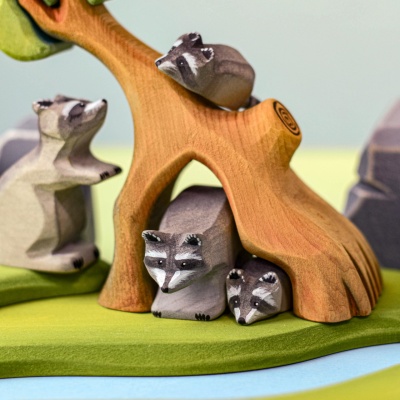 accoon family hiding under a wooden tree, handcrafted wooden toys by Bumbu Toys