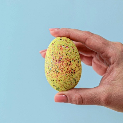 A child's hands excitedly cracking open one of the stegosaurus eggs.