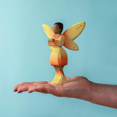 Handcrafted Sunflower Fairy in vibrant yellow hues.