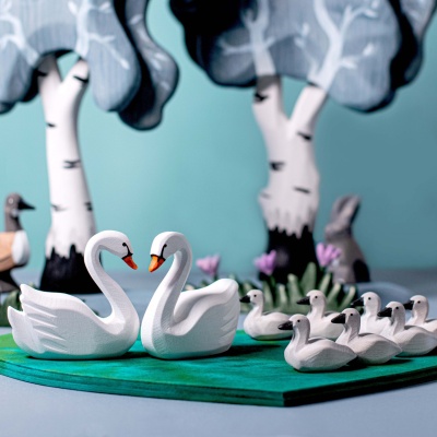 Bumbu Toys' depiction of swans in harmony, floating on a lake of love.