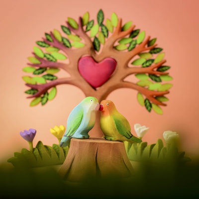 Tree Stump and Lovebirds in a whimsical forest setting with a heart-shaped tree in the background.