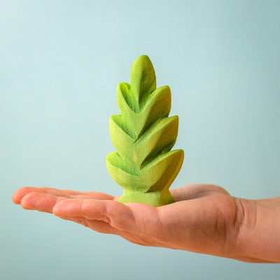 Hand holding the Thuja Shrub wooden toy.