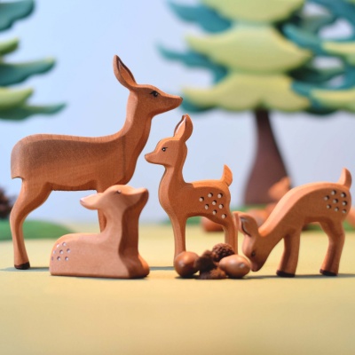 Close-up photo showcasing the smooth, sanded texture of the wooden fawn toy.