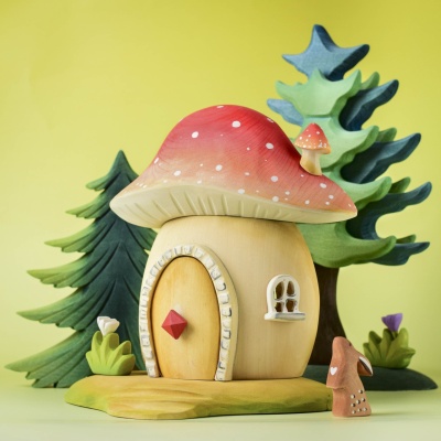 Toadstool House in a magical woodland setting with trees and animals.
