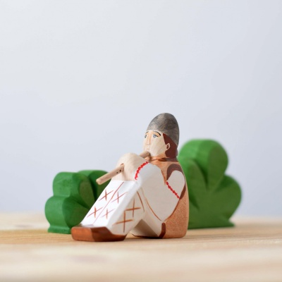 Shepherd with Flute displayed on a child's bedroom bookshelf.