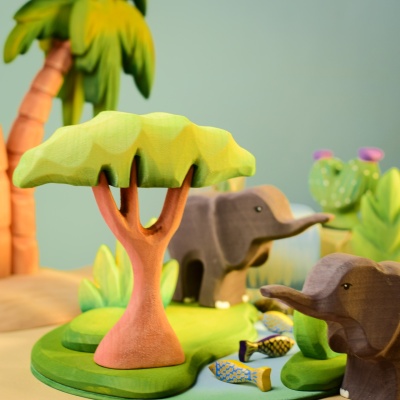 Small Acacia Tree toy in a play scene with wooden elephants.