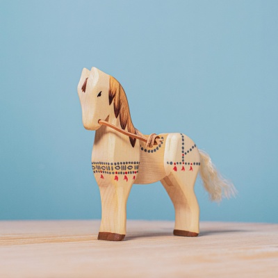 Detailed view of the wooden horse, highlighting its carved mane and saddle.