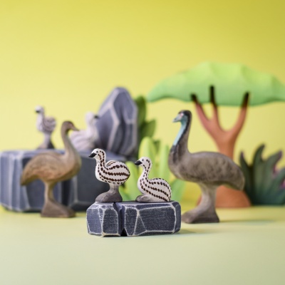 Emu chicks and adult birds in a colorful nature-inspired toy setup