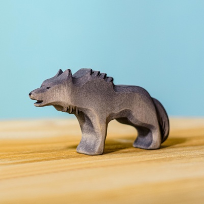 Child playing with the eco-friendly, handcrafted Wolf Angry figurine