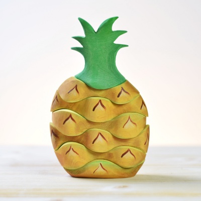 Bright and cheerful wooden Pineapple toy by BumbuToys, encouraging creative play and learning.