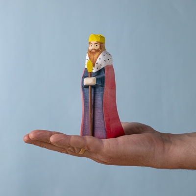 Wooden King figure shown in hand for size and detail.