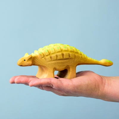 Wooden Ankylosaurus Big held in a hand for size comparison
