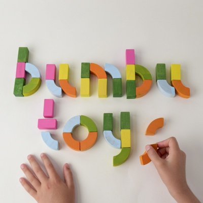 Close-up of individual blocks showing letters, numbers, and illustrations.