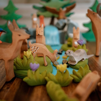 Bumbu Toys' wooden fawn in resting position, exuding calm.