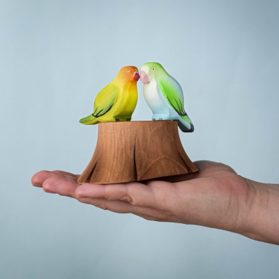 Green and Blue Lovebirds sitting on the Tree Stump, captured in a whimsical nature-inspired scene with a heart-shaped tree in the background.