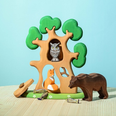 The warm, natural wood grain of the fox figurine illuminated by sunlight.