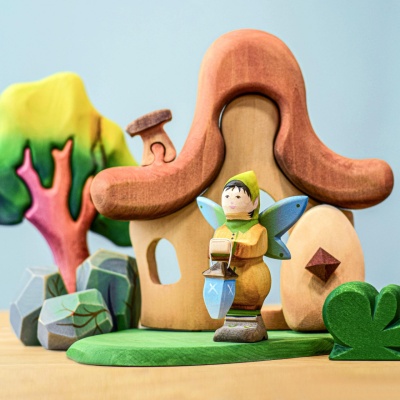 Wooden figurine of a guardian elf with a lamp.