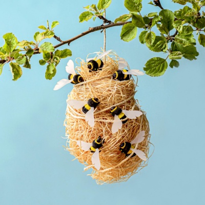 Detailed view of a wooden bumblebee toy in natural setting